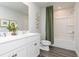 Bright bathroom featuring a double vanity, modern fixtures, and a shower with green curtain at 610 Belshire Dr, Acworth, GA 30102