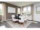 Bright dining room with dark wood table, modern chairs, rug, three light pendant and lots of natural light at 610 Belshire Dr, Acworth, GA 30102