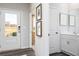 Bright foyer view to front door and glimpse of powder room with modern fixtures and decor at 610 Belshire Dr, Acworth, GA 30102