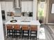 Modern kitchen featuring a large island with bar stool seating, pendant lighting, and white cabinetry at 610 Belshire Dr, Acworth, GA 30102