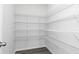 Spacious walk-in closet featuring ample shelving space for organized storage and a grey wood floor at 610 Belshire Dr, Acworth, GA 30102