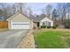 Charming single-story home with neutral siding, brick accents, and a well-maintained front lawn at 1715 Fort Daniels Trl, Dacula, GA 30019