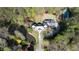 Stunning aerial view of a grand estate with pond, garden, tennis court, and circular driveway at 4615 Northside Dr, Atlanta, GA 30327