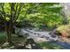 Stone path leads through a meticulously landscaped backyard oasis at 4615 Northside Dr, Atlanta, GA 30327