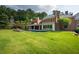 Extensive backyard showcasing a sparkling pool, lounge chairs, and lush greenery at 4615 Northside Dr, Atlanta, GA 30327