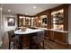 Basement bar area featuring ample shelving, a marble countertop, and hardwood floors at 4615 Northside Dr, Atlanta, GA 30327