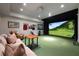 Basement theater with a large projector screen and a golf simulator at 4615 Northside Dr, Atlanta, GA 30327