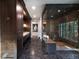 Modern bathroom with dark wood cabinets, marble floors, and a glass-enclosed shower with a bench at 4615 Northside Dr, Atlanta, GA 30327