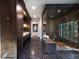 Luxurious bathroom featuring dark wood cabinets, marble floors, and an elegant walk-in shower with a built-in bench at 4615 Northside Dr, Atlanta, GA 30327
