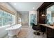 Bright bathroom with a soaking tub, glass shower, and elegant vanity area at 4615 Northside Dr, Atlanta, GA 30327