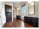 Elegant bathroom with dual sinks, dark wood vanities, marble countertops and floors, and a separate makeup area at 4615 Northside Dr, Atlanta, GA 30327