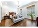 Bright bedroom with hardwood floors, natural light, a decorative rug, and a comfortable sitting area at 4615 Northside Dr, Atlanta, GA 30327