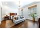 Light and airy bedroom with a seating area, chandelier, and two large windows at 4615 Northside Dr, Atlanta, GA 30327