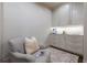 This compact pantry features custom cabinets, a small sink, and a cozy armchair at 4615 Northside Dr, Atlanta, GA 30327