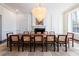 Bright dining room with a large table, unique chandelier and view of manicured outdoor space at 4615 Northside Dr, Atlanta, GA 30327