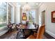 Elegant dining room with large windows, chandelier, and unique dark wood table at 4615 Northside Dr, Atlanta, GA 30327