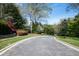 Paver driveway lined with manicured lawns and mature trees at 4615 Northside Dr, Atlanta, GA 30327