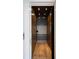 Modern wood-paneled elevator featuring black metal safety gate and recessed lighting at 4615 Northside Dr, Atlanta, GA 30327