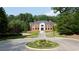 Stately brick home with a circular driveway and lush landscaping at 4615 Northside Dr, Atlanta, GA 30327