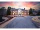 Striking front exterior view of brick home with manicured lawn and sunset sky at 4615 Northside Dr, Atlanta, GA 30327
