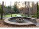 Stone fire pit and wood storage area overlooking the putting green and sand trap at 4615 Northside Dr, Atlanta, GA 30327