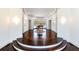 Open foyer with curved stairs, hardwood floors, bay window, and decorative lighting fixtures at 4615 Northside Dr, Atlanta, GA 30327