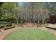 Manicured lawn featuring terraces, brick walkways, and bench seating at 4615 Northside Dr, Atlanta, GA 30327