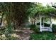 Pathway leading to a charming gazebo with a bench, surrounded by lush greenery and mature trees at 4615 Northside Dr, Atlanta, GA 30327