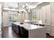 Spacious kitchen featuring a large center island, modern lighting, and stainless steel appliances at 4615 Northside Dr, Atlanta, GA 30327