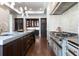Elegant kitchen boasting a chef's range, marble countertops, and custom cabinetry with gold hardware at 4615 Northside Dr, Atlanta, GA 30327