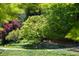 Lush landscaping with mature trees, shrubs, and manicured lawn at 4615 Northside Dr, Atlanta, GA 30327