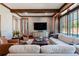 This cozy living room offers large windows, wood beams, and comfortable seating for a relaxing atmosphere at 4615 Northside Dr, Atlanta, GA 30327