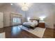 Spacious main bedroom with hardwood floors, chandelier, window and neutral tones at 4615 Northside Dr, Atlanta, GA 30327