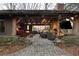 Outdoor living space with stone fireplace, TV, and comfortable seating with pavers under post and beam roof at 4615 Northside Dr, Atlanta, GA 30327