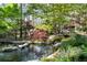 Picturesque pond with rock features, lush landscaping, and serene waterfall leading to covered pavilion at 4615 Northside Dr, Atlanta, GA 30327