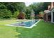 Inviting backyard pool with lounge seating surrounded by lush landscaping at 4615 Northside Dr, Atlanta, GA 30327