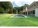 Inviting backyard pool with lounge seating surrounded by lush landscaping at 4615 Northside Dr, Atlanta, GA 30327