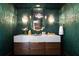 Stylish powder room featuring unique wallpaper, decorative lighting, and a modern sink at 4615 Northside Dr, Atlanta, GA 30327