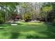 Scenic putting green with multiple holes, a sand trap, and wooded views in the distance at 4615 Northside Dr, Atlanta, GA 30327