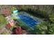 An overhead view of a pristine blue and green tennis court with an adjacent brick patio at 4615 Northside Dr, Atlanta, GA 30327