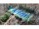 An aerial view of a private tennis court with blue and green surface, surrounded by greenery at 4615 Northside Dr, Atlanta, GA 30327