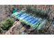Aerial view of a private tennis court surrounded by lush greenery at 4615 Northside Dr, Atlanta, GA 30327