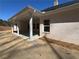 A covered patio area with support pillars, concrete flooring, and view of the yard at 5311 Tuscany Drive, Douglasville, GA 30135