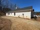 Side view of a brick home showing utility connections, windows, and landscaped grounds at 5311 Tuscany Drive, Douglasville, GA 30135