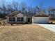 Charming single-story home with a brick facade, two-car garage, and manicured front yard at 5311 Tuscany Drive, Douglasville, GA 30135