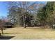 Expansive backyard with mature trees creating a beautiful outdoor space at 1655 Old Salem Rd, Covington, GA 30013