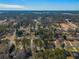 This aerial community view showcases the neighborhood and many mature trees at 1890 Carla Dr, Morrow, GA 30260