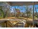 View of the backyard from the back porch, with a large grassy area surrounded by mature trees at 1890 Carla Dr, Morrow, GA 30260