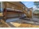 View of backyard showing covered patio, exposed beam structure and stairs to the raised porch at 1890 Carla Dr, Morrow, GA 30260