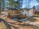 Aerial view of backyard with a wooden deck and a unique stone paved path at 1890 Carla Dr, Morrow, GA 30260